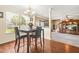 Open concept dining area featuring wood floors, chandelier and view into the living area at 160 Oak Manor Dr, Covington, GA 30016