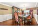 Formal dining room with wood floors, chandelier and decorative wainscoting at 160 Oak Manor Dr, Covington, GA 30016