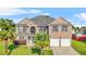 Two-story brick home with a two-car garage, well-manicured lawn and lush landscaping at 160 Oak Manor Dr, Covington, GA 30016