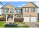 Two-story brick home with a two-car garage, with a charming front porch and walkway at 160 Oak Manor Dr, Covington, GA 30016