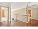 Upstairs hallway with wood floors and neutral walls at 160 Oak Manor Dr, Covington, GA 30016