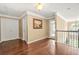 Upstairs hallway with neutral paint, wood flooring, and plenty of light at 160 Oak Manor Dr, Covington, GA 30016
