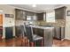 Updated kitchen with wood floors, dark cabinets, stainless appliances, tile backsplash, and granite countertops at 160 Oak Manor Dr, Covington, GA 30016