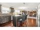 Open floor plan kitchen with wood floors, dark cabinets, granite counters, stainless appliances, and seating at 160 Oak Manor Dr, Covington, GA 30016