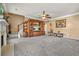 Spacious living room features plush carpeting, entertainment center, and staircase at 160 Oak Manor Dr, Covington, GA 30016