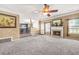 Spacious living room with fireplace, open to the kitchen, and multiple windows at 160 Oak Manor Dr, Covington, GA 30016