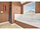 Serene main bathroom featuring a large soaking tub and a bright, airy ambiance at 160 Oak Manor Dr, Covington, GA 30016