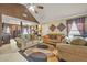 Comfortable primary bedroom featuring a seating area, ceiling fan, and ample natural light at 160 Oak Manor Dr, Covington, GA 30016