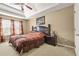 Spacious main bedroom features a decorative ceiling fan, large bed and side table at 160 Oak Manor Dr, Covington, GA 30016