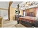 Main bedroom with neutral carpets, four poster bed, and windows at 160 Oak Manor Dr, Covington, GA 30016