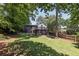 A spacious backyard with a deck and seating area, surrounded by lush greenery at 382 Lofton Nw Rd, Atlanta, GA 30309
