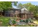 A lovely backyard with a stone patio and fire pit surrounded by comfortable chairs at 382 Lofton Nw Rd, Atlanta, GA 30309