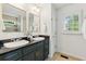 Bathroom featuring double sinks, granite countertop and window at 382 Lofton Nw Rd, Atlanta, GA 30309
