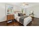 Cozy bedroom features a queen bed, natural light, hardwood floors, and stylish decor at 382 Lofton Nw Rd, Atlanta, GA 30309