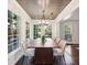 Spacious dining room with a long table, eight chairs, and plenty of natural light at 382 Lofton Nw Rd, Atlanta, GA 30309