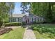 Charming single-story home featuring a well-manicured lawn, a stone walkway, and a welcoming red front door at 382 Lofton Nw Rd, Atlanta, GA 30309