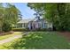 Charming single-story home features a well-manicured lawn, a stone walkway, and a welcoming red front door at 382 Lofton Nw Rd, Atlanta, GA 30309