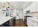 Modern kitchen with white cabinets, stainless steel appliances, large sink and hardwood floors at 382 Lofton Nw Rd, Atlanta, GA 30309