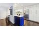 Modern kitchen with a blue island, white cabinets, and stainless steel appliances at 382 Lofton Nw Rd, Atlanta, GA 30309