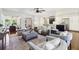 Well-lit living room with stylish seating, hardwood floors, and views to the kitchen and dining areas at 382 Lofton Nw Rd, Atlanta, GA 30309