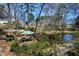 A serene pond featuring a community park area with tables, umbrellas, and lush landscaping at 382 Lofton Nw Rd, Atlanta, GA 30309