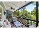 Screened-in porch features outdoor seating, a ceiling fan, and serene views of the surrounding trees at 382 Lofton Nw Rd, Atlanta, GA 30309