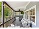 Covered porch features outdoor seating, a ceiling fan, and serene views of the surrounding yard at 382 Lofton Nw Rd, Atlanta, GA 30309