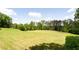 Expansive backyard surrounded by lush greenery, offering ample space for outdoor activities and recreation at 6505 Hampton Creek Dr, Cumming, GA 30041