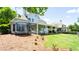 Expansive backyard featuring a well-maintained lawn, covered patio, and trampoline at 6505 Hampton Creek Dr, Cumming, GA 30041