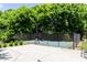 Fenced basketball court surrounded by trees in a sunny outdoor setting at 6505 Hampton Creek Dr, Cumming, GA 30041