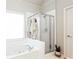 Bright bathroom with a soaking tub and separate glass-enclosed shower, complemented by neutral tones at 6505 Hampton Creek Dr, Cumming, GA 30041