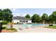 Inviting community pool area with lounge chairs, mature trees, and an adjacent clubhouse at 6505 Hampton Creek Dr, Cumming, GA 30041