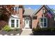 Elegant brick home showcasing a decorative door with front garden, and lush landscaping at 6505 Hampton Creek Dr, Cumming, GA 30041