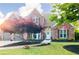 Charming two-story brick home featuring a manicured front yard, mature landscaping, and inviting curb appeal at 6505 Hampton Creek Dr, Cumming, GA 30041