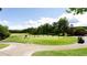 Scenic golf course view with golfers, manicured greens, trees, and a golf cart at 6505 Hampton Creek Dr, Cumming, GA 30041