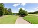Picturesque golf course view with lush green fairways and a tranquil lake in the background at 6505 Hampton Creek Dr, Cumming, GA 30041
