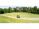 Scenic golf course view, featuring a golf cart path, lush green grass, and mature trees in the background at 6505 Hampton Creek Dr, Cumming, GA 30041