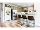 Eat in kitchen with marble countertops, stainless steel appliances, and modern barstool seating at 6505 Hampton Creek Dr, Cumming, GA 30041