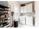 Well-organized laundry room featuring a washer, dryer, storage cabinets, and shelving for efficient space utilization at 6505 Hampton Creek Dr, Cumming, GA 30041