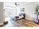 Serene bedroom with tray ceiling, fireplace, large windows offering views and hardwood floors at 6505 Hampton Creek Dr, Cumming, GA 30041