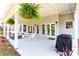 Covered patio with outdoor seating, ceiling fans, and a grill, perfect for entertaining at 6505 Hampton Creek Dr, Cumming, GA 30041