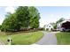 A beautiful street view featuring mature trees, manicured lawns and attractive well-maintained homes at 6505 Hampton Creek Dr, Cumming, GA 30041