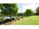 Well-maintained tennis court surrounded by lush greenery and landscaped gardens at 6505 Hampton Creek Dr, Cumming, GA 30041