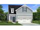 Charming two-story home with gray siding, a two-car garage, and a well-manicured front yard at 80 Hydrangea Cir, Fairburn, GA 30213