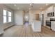 Open-concept living space with hardwood floors, a kitchen island and great natural light at 80 Hydrangea Cir, Fairburn, GA 30213