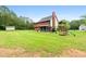 Expansive backyard featuring a screened porch, play set, storage shed, and lush greenery at 117 Constance Dr, Locust Grove, GA 30248