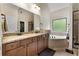 Elegant bathroom with double vanity, granite countertop, and soaking tub at 117 Constance Dr, Locust Grove, GA 30248