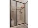 Beautifully tiled shower with glass door, built-in seat, and decorative accents at 117 Constance Dr, Locust Grove, GA 30248