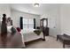Bedroom features a full bed frame, dresser and lots of natural light at 117 Constance Dr, Locust Grove, GA 30248