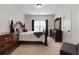 Bedroom features a full bed frame, dresser and lots of natural light at 117 Constance Dr, Locust Grove, GA 30248